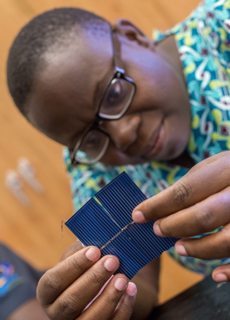 A Mandela Fellow working on a solar panel