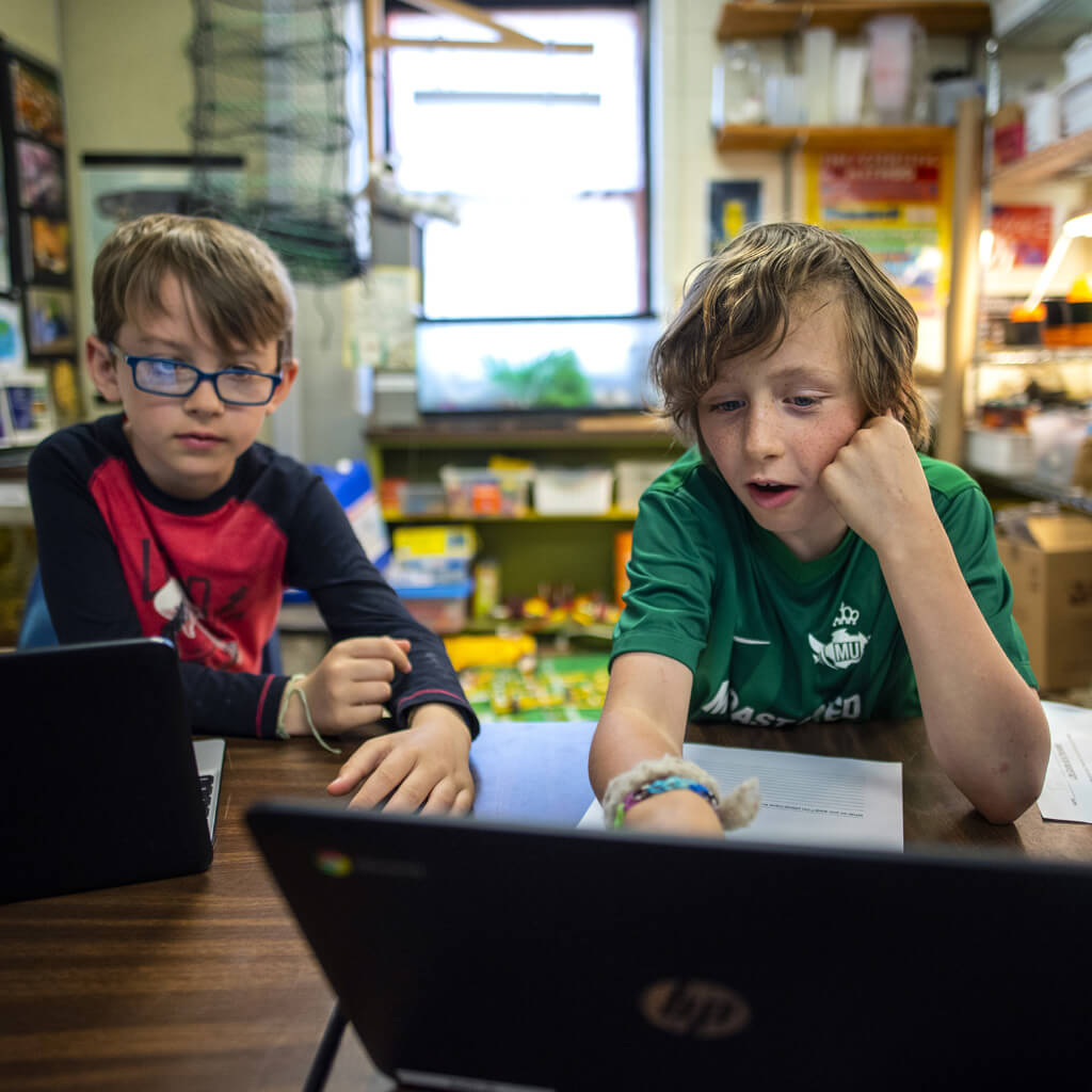 Students looking at a laptop