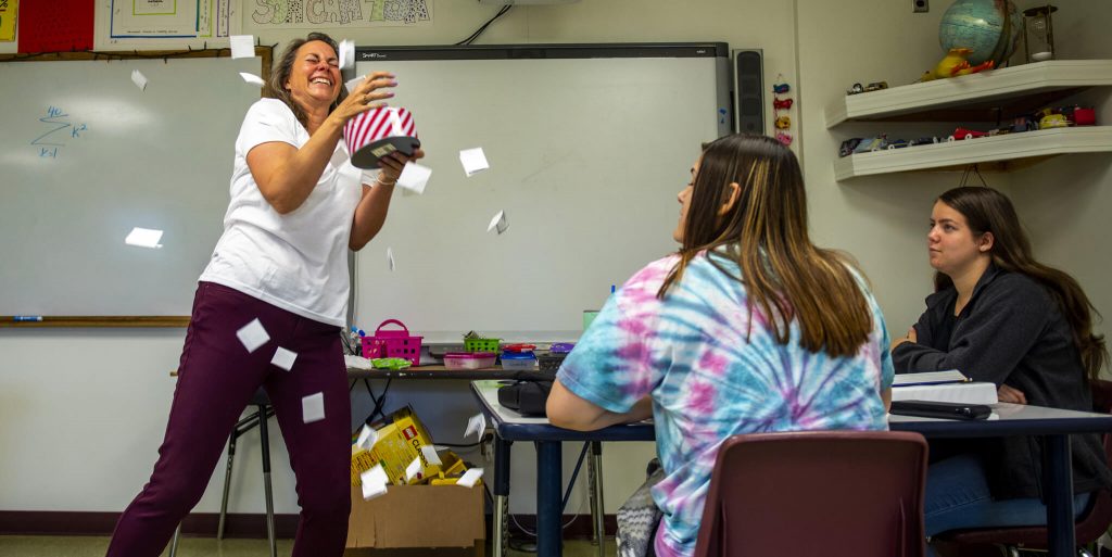 Teacher with cards flying