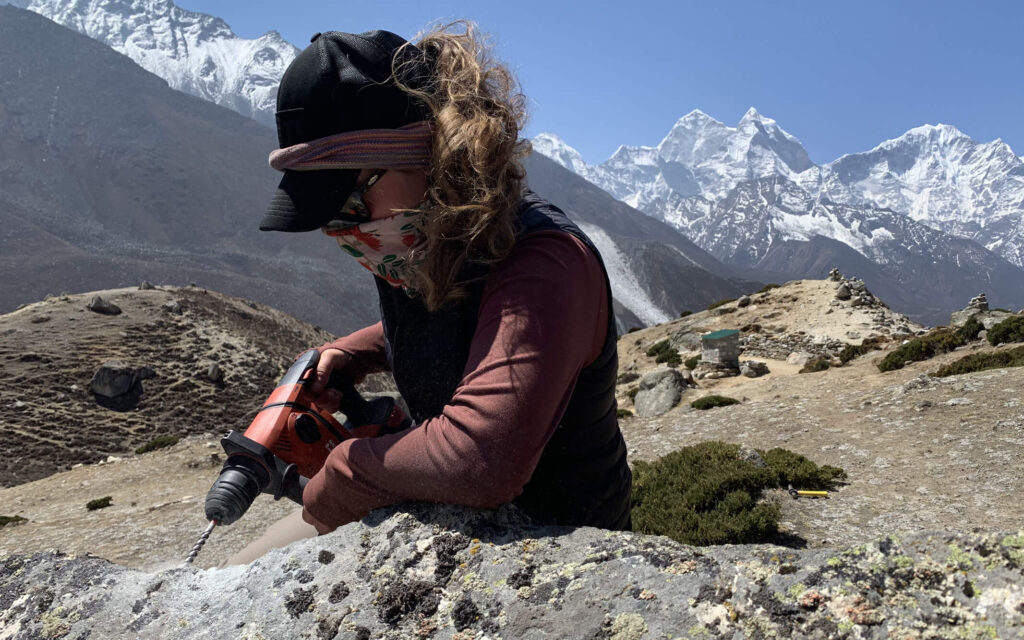 Researcher drills into a rock