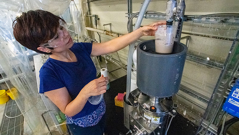 Evaluating a freshly produced sample of nanocellulose slurry at the Process Development Center.